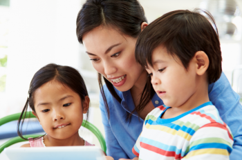 Mum and small children on tablet